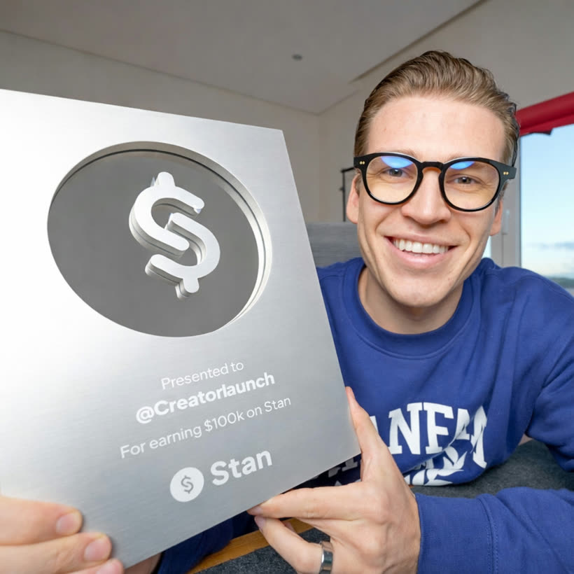 Dylan holding a Stan $100k creator plaque